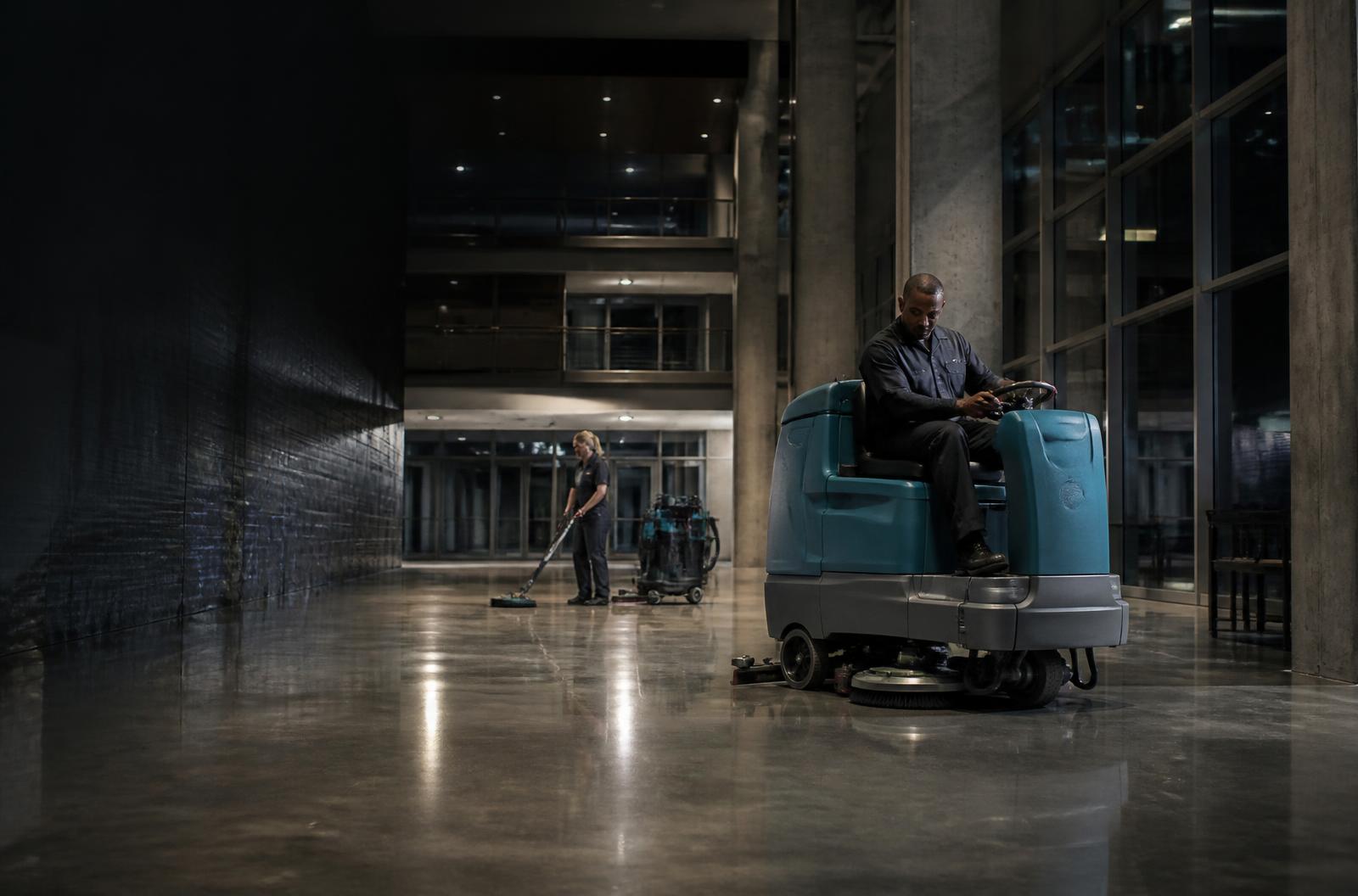 Professional cleaner restoring a floor in a large commercial facility